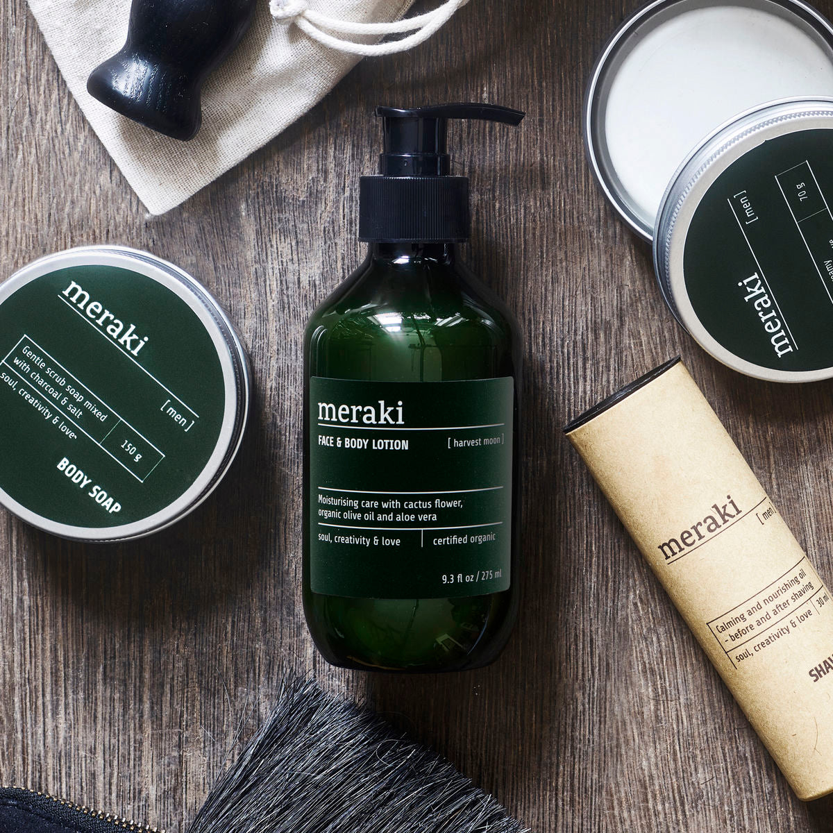 A dark green bottle with black pump and a label that says 'Meraki Face & Body Lotion'