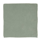 A square knitted cloth in a dusty green colour.
