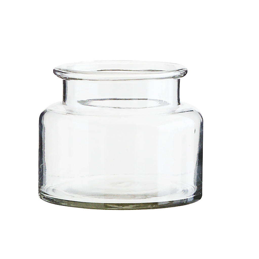 Short clear glass vase in thick glass, with a slightly thinner neck and a lip around the top of the vase.