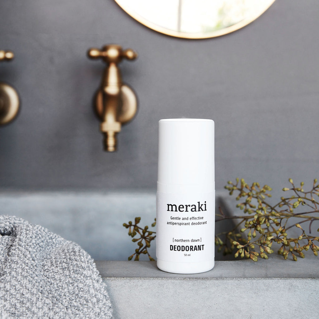 White bottle with lid and black text 'Meraki gentle and effective antiperspirant deodorant [northern dawn] Deodorant 50ml'