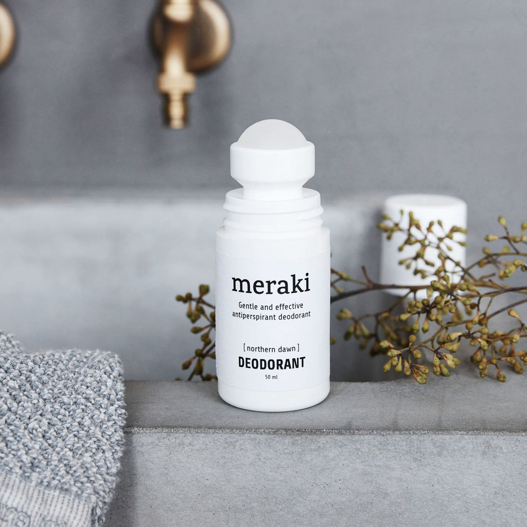 White bottle with lid and black text 'Meraki gentle and effective antiperspirant deodorant [northern dawn] Deodorant 50ml'